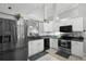Bright kitchen features white cabinets, stainless steel appliances, and tiled backsplash at 1848 Jimson Ave, Ocoee, FL 34761