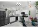 Bright kitchen with white cabinets, black appliances, eat-in area, and stylish tile flooring at 1848 Jimson Ave, Ocoee, FL 34761