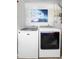 Clean laundry room with a side-by-side washer and dryer and modern decor at 1848 Jimson Ave, Ocoee, FL 34761