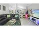 Spacious living room with stylish decor, black leather sofa, and view of the dining room at 1848 Jimson Ave, Ocoee, FL 34761