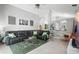 Open living room with high ceilings, black leather sofa, and a view to the kitchen at 1848 Jimson Ave, Ocoee, FL 34761