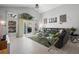 Living room with a black leather sofa, area rug, and sliding glass doors to patio at 1848 Jimson Ave, Ocoee, FL 34761