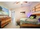 Well-lit main bedroom featuring a wood dresser and view into the ensuite bath and walk-in closet at 1848 Jimson Ave, Ocoee, FL 34761