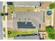 Aerial view of the home featuring a roof with solar panels, a paved driveway, and a fenced backyard with a trampoline at 210 Hydra Way, Groveland, FL 34736