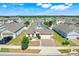 Aerial shot of the home showing solar panels, a paved driveway, and neatly kept landscaping in a well-developed neighborhood at 210 Hydra Way, Groveland, FL 34736