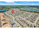 Aerial view of a neighborhood with a waterway in the background at 210 Hydra Way, Groveland, FL 34736