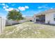 Backyard view with partial grass and a screened in porch at 210 Hydra Way, Groveland, FL 34736
