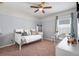Bright bedroom with a ceiling fan, providing a comfortable space for rest and relaxation or an enjoyable work space at 210 Hydra Way, Groveland, FL 34736