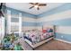 bedroom features a blue and white color scheme and large window for natural light at 210 Hydra Way, Groveland, FL 34736
