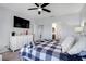 Cozy bedroom featuring a ceiling fan, a large dresser, and access to the ensuite bathroom and walk-in closet at 210 Hydra Way, Groveland, FL 34736