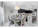 Open dining area with modern chandelier, table seating for six, and kitchen views at 210 Hydra Way, Groveland, FL 34736