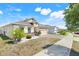 Attractive single-story home with a manicured lawn, brick-paved driveway, and a convenient two-car garage at 210 Hydra Way, Groveland, FL 34736