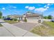 Charming single-story home with a brick-paved driveway, two-car garage, and manicured front lawn at 210 Hydra Way, Groveland, FL 34736