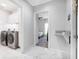 Hallway features tiled flooring, laundry room access, and bedroom access at 210 Hydra Way, Groveland, FL 34736