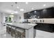 Modern kitchen with granite countertops, stainless steel appliances, dark wood cabinets, and a large island with seating at 210 Hydra Way, Groveland, FL 34736