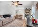 Cozy living room with neutral paint, carpet, and furniture plus ample natural light at 210 Hydra Way, Groveland, FL 34736