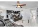Open-concept living room with a ceiling fan, tile floors, and views of the kitchen at 210 Hydra Way, Groveland, FL 34736