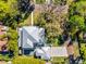 Stunning aerial view of a modern home featuring a unique roof, lush landscaping, and a refreshing pool at 2171 Forrest Rd, Winter Park, FL 32789