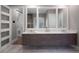 Sleek bathroom with floating vanity, dual sinks, modern mirrors, and marble floors at 2171 Forrest Rd, Winter Park, FL 32789