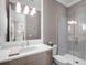 Elegant bathroom with a stylish vanity, quartz counters and glass shower at 2171 Forrest Rd, Winter Park, FL 32789