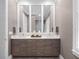 Bathroom featuring dual sinks, modern lighting, and a large mirror at 2171 Forrest Rd, Winter Park, FL 32789