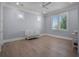 Light-filled bedroom featuring a ceiling fan, plantation shutters and a baby crib at 2171 Forrest Rd, Winter Park, FL 32789