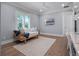 Relaxing bedroom with natural light, hardwood floors, and a cozy seating area at 2171 Forrest Rd, Winter Park, FL 32789
