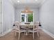 This dining room features a unique hanging light fixture and a beautiful window to let in natural light at 2171 Forrest Rd, Winter Park, FL 32789