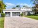 Beautiful two-story home with a well-manicured lawn, a wide driveway, and a modern gray and white color scheme at 2171 Forrest Rd, Winter Park, FL 32789