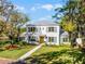 Charming two-story home with manicured lawn, gray metal roof and blue shutters at 2171 Forrest Rd, Winter Park, FL 32789