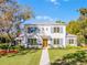 Stunning two-story home with a manicured lawn, gray metal roof and blue shutters at 2171 Forrest Rd, Winter Park, FL 32789