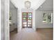Elegant foyer with hardwood floors, a chandelier, and a wood-framed glass door at 2171 Forrest Rd, Winter Park, FL 32789