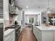 Modern kitchen with a breakfast bar, stainless steel appliances, and custom cabinets at 2171 Forrest Rd, Winter Park, FL 32789