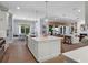 Bright kitchen with an oversized island, stainless steel appliances, and an open concept design to the living room at 2171 Forrest Rd, Winter Park, FL 32789