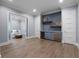 Sitting area with a wet bar with a beverage fridge, custom cabinets and shelving at 2171 Forrest Rd, Winter Park, FL 32789