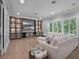 Spacious living room with a large built-in entertainment center and a comfortable sectional sofa at 2171 Forrest Rd, Winter Park, FL 32789