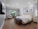 Spacious main bedroom featuring a sitting area, large windows, recessed lighting, and stylish decor at 2171 Forrest Rd, Winter Park, FL 32789