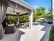 Beautiful outdoor pool area with covered patio, lounge furniture, and lush landscaping providing a tranquil retreat at 2171 Forrest Rd, Winter Park, FL 32789