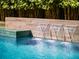 Elegant pool showcasing a modern water feature that enhances the backyard's serene and luxurious atmosphere at 2171 Forrest Rd, Winter Park, FL 32789