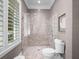 Modern shower with mosaic tiling, glass door, and rain shower head at 2171 Forrest Rd, Winter Park, FL 32789