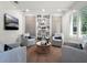 Inviting sitting room with built-in bookshelves and comfortable seating at 2171 Forrest Rd, Winter Park, FL 32789