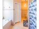 Bright bathroom featuring tiled walls, a bathtub, and a shower with a nautical-themed curtain at 225 Loma Del Sol Dr, Davenport, FL 33896