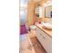 Bathroom with a unique vanity, tiled floors, and cabinet storage at 225 Loma Del Sol Dr, Davenport, FL 33896
