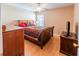 Cozy bedroom features ceiling fan, wood furnishings, and a bright window at 225 Loma Del Sol Dr, Davenport, FL 33896