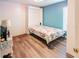 Cozy bedroom featuring a Murphy bed and wood-look laminate flooring at 225 Loma Del Sol Dr, Davenport, FL 33896