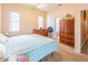 Bright bedroom features carpeted floors, three windows, and open bathroom entrance at 225 Loma Del Sol Dr, Davenport, FL 33896