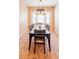 Bright dining room with a dark wood table, bay window, and vintage chandelier at 225 Loma Del Sol Dr, Davenport, FL 33896