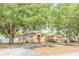Well-maintained home featuring mature trees and a spacious front yard at 225 Loma Del Sol Dr, Davenport, FL 33896