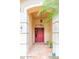 Inviting entryway with a red front door, tiled floor, and charming decor at 225 Loma Del Sol Dr, Davenport, FL 33896