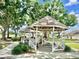 Community gazebo featuring a white picket fence and shaded seating area at 225 Loma Del Sol Dr, Davenport, FL 33896